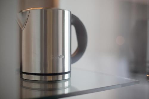 a coffee pot sitting on top of a counter at Pullman Sydney Airport in Sydney
