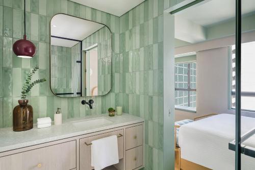 a bathroom with a sink and a mirror at YING'nFLO, Hong Kong, Wan Chai in Hong Kong