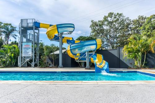 a water slide in a pool at a resort at Nobby Beach Holiday Village in Gold Coast