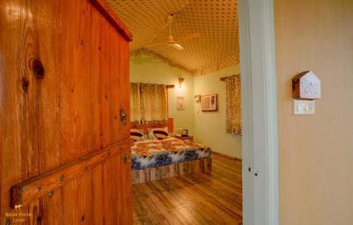 a room with a bedroom with a bed in it at Ranthambhore Bagh Dwar Camp in Khilchipur