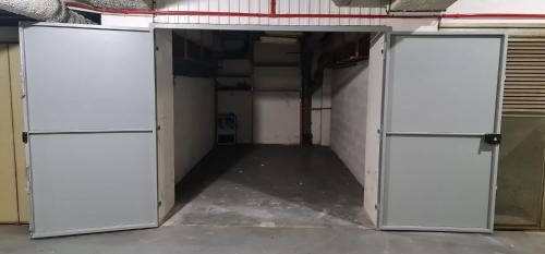 an empty room with two refrigerators in a garage at Amazing View Port Golfe-Juan and Garage in Golfe-Juan
