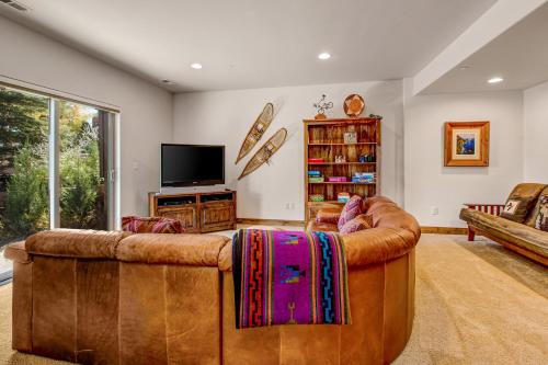 a living room with a large couch and a television at Cedar Haven in Park City