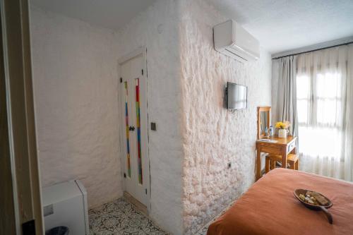 um quarto com uma cama e uma porta colorida em Ajlan Hotel Cunda em Ayvalik