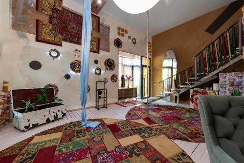 a living room with a large rug on the floor at Inn OZZ in Karagandy
