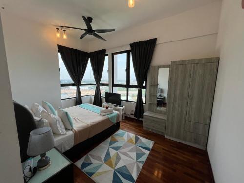 a bedroom with a bed and a ceiling fan at D'Gunduls Homestay Family Suite 2R 2B by DGH I-CITY in Shah Alam