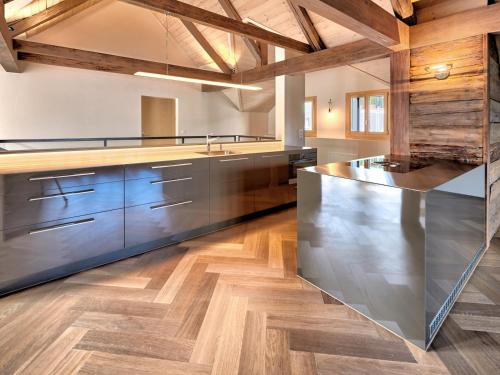 a kitchen with wooden floors and a large counter top at Boutique Guesthouse Villa Pescheria B&B in Weggis