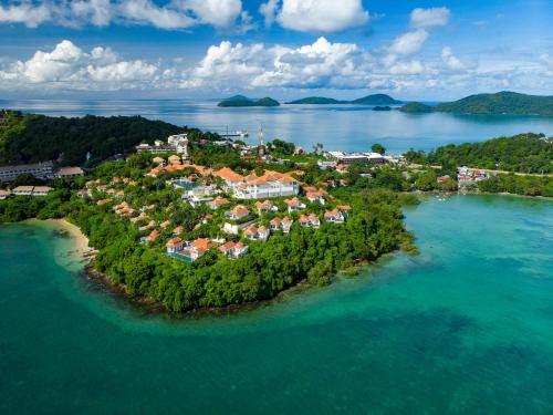 an island in the water with houses on it at Amatara Welleisure Resort in Panwa Beach