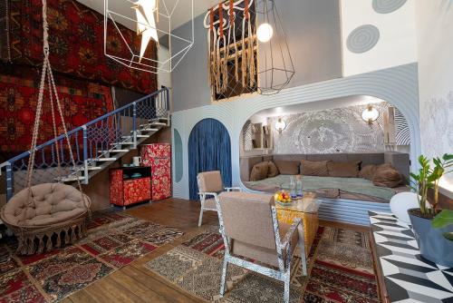 a bedroom with a bed and a staircase in a room at Inn OZZ in Karagandy