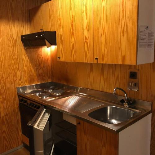 a small kitchen with a sink and a stove at Marrileva-Folgarida, Apartmán v Residence Albare in Mezzana