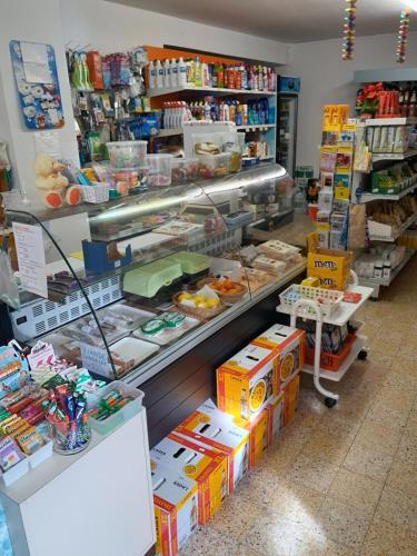 a store with a counter with boxes of food at Soubey (Clairbief) in Soubey