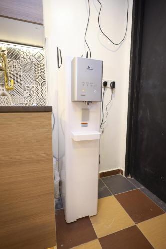 a room with a toilet with a box on the wall at RENTIO HOTEL in Kulim