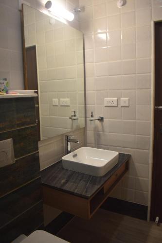 a bathroom with a sink and a mirror at Oro Montana Hotels and Resort in Gangtok