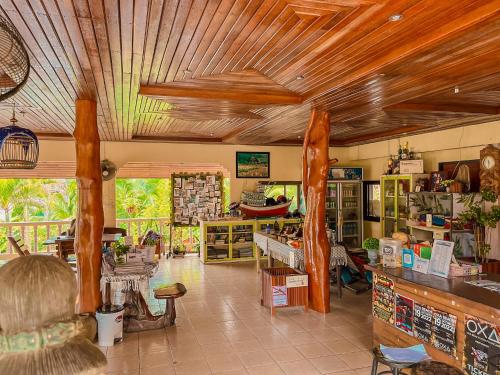 a room with a store with wooden ceilings at Tanouy Garden in Baan Khai