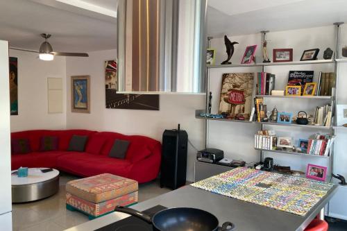 a living room with a red couch and a table at La maison Chanti - La Saline in Le Barrage
