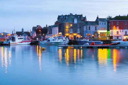 a harbor with boats in the water at night at Seasteps Padstow in Padstow