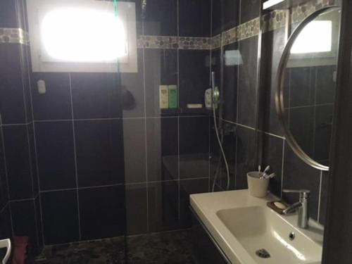 a bathroom with a sink and a mirror at Appartement à 20 mètres de la plage avec balcon in Marseille
