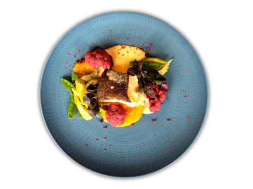 a blue plate of food on a white background at Hotel Olympic Spa & Wellness in Ustroń