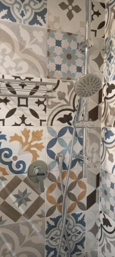 ein Bad mit einer Fliesenwand und einer Dusche in der Unterkunft Come nelle favole home in Bari