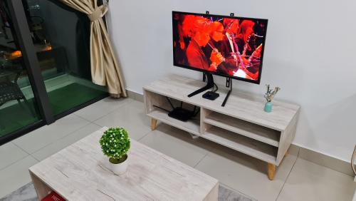 a living room with a flat screen tv on a table at Luxury 5STAR 2Room Resort Suite Mid Valley Sunway Kuala Lumpur by Stayz Suites in Kuala Lumpur