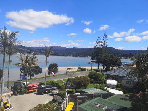 a view of a beach and a body of water at Paku Lodge Resort in Tairua