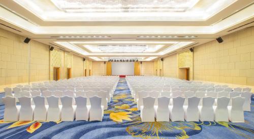 a conference room with a row of chairs and a table at Crowne Plaza Shenzhen Longgang City Centre by IHG in Longgang