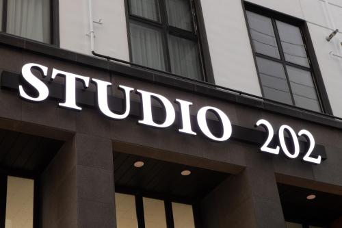 a building with a sign on the side of it at Busan Studio 202 in Busan