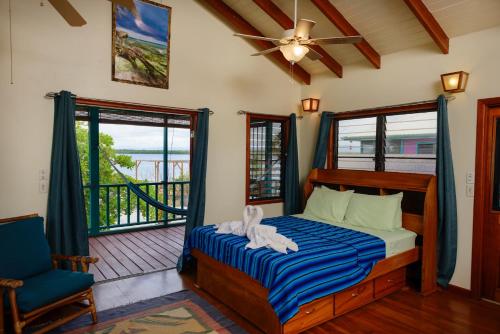 a bedroom with a bed and a balcony at Sunset Lagoon Cabanas in Maya Beach