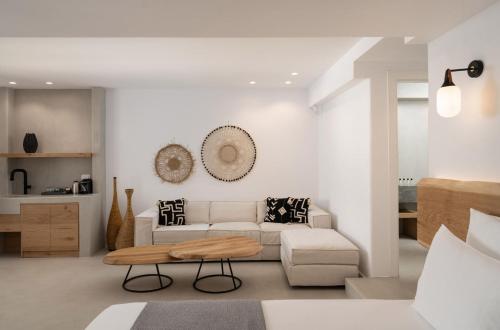 a living room with a couch and a table at La Ponta Villas & Suites in Akrotiri