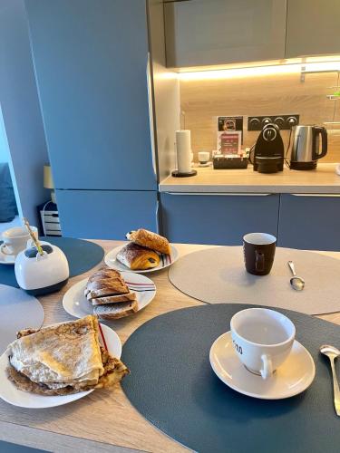 a table with plates of food and a cup of coffee at Studio Disneyland Paris Holidays in Montévrain