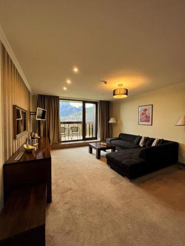 a living room with a couch and a table at President Hotel Montfort in Ždiar