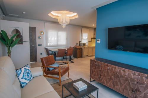 a living room with a large flat screen tv at Apartamentos Turísticos La Baílla in Rota