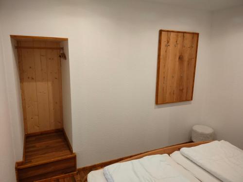 Zimmer mit einem Bett, einem Spiegel und einer Tür in der Unterkunft Ferienhaus Kaufmanns Cafe in Kurort Oberwiesenthal