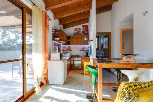a kitchen with a table and a counter top at Samarighouse in Putzu Idu