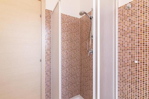 a bathroom with a shower with red tiles at Appartamento Custonaci Uno in Custonaci