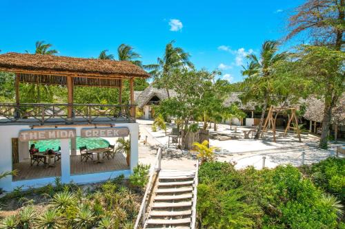 a view of a resort with tables and chairs at The Mida Creek Hotel in Watamu