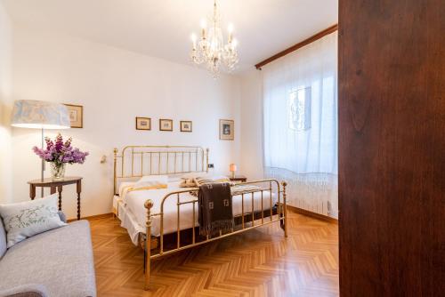 a bedroom with a bed and a chandelier at Casa Dolce Casa in Montepulciano