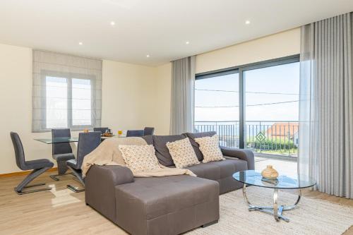 a living room with a couch and a table at Canhas Residence I by Homie in Ponta do Sol