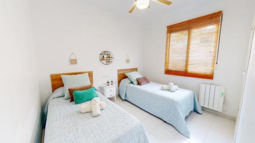Katil atau katil-katil dalam bilik di Apartamento Jazmín