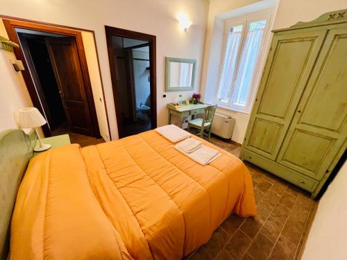una camera con un grande letto arancione e una scrivania di Podere La Miniera Relax & Food a Siena
