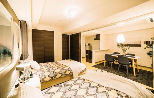 a hotel room with a bed and a desk at Universal Haneda in Tokyo