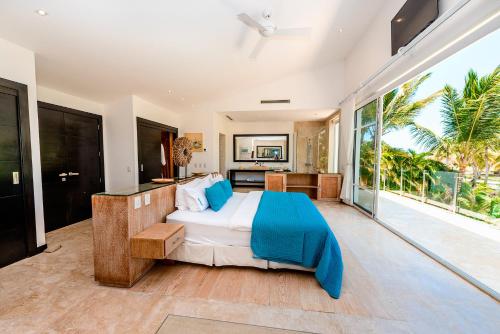 a bedroom with a bed and a large window at Luxury Villa Waterfall with Private Pool, BBQ & Maid in Punta Cana