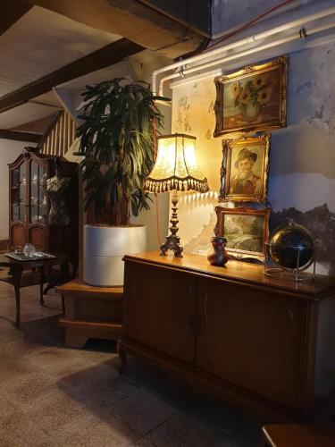 a room with a lamp and paintings on a wall at Stillvolle Designwohnung im historischen Zentrum in Stolberg i. Harz