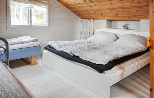 a bedroom with two beds and a window at Beautiful Home In Bovik With Wifi 