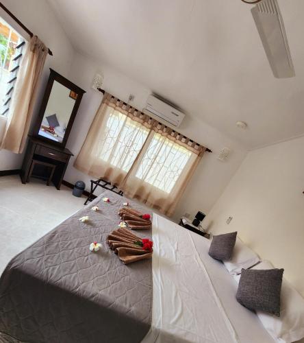 a bedroom with a large bed and a window at Kaz Memel in Beau Vallon
