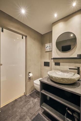 a bathroom with a sink and a mirror at Chalet Alpenruhe in Oberstaufen