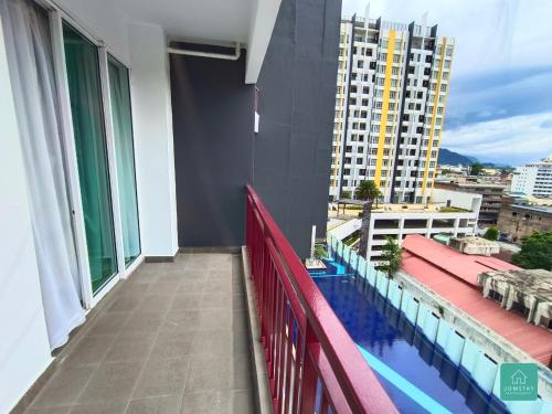 a balcony of a building with a swimming pool at JOMSTAY Majestic Ipoh Suites in Ipoh
