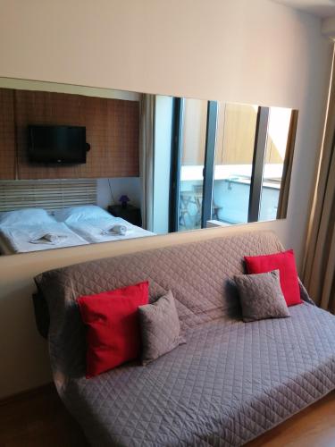 a couch with four pillows on it in a bedroom at Panorama Apartmany in Štrbské Pleso