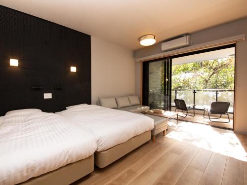 a bedroom with a large bed and a large window at Rakuten STAY MOTEL Nikko Kinugawa Dog Friendly Room in Nikko