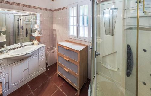 a bathroom with a sink and a glass shower at Nice Home In Ferrires-poussarou With Kitchen in Ferrières-Poussarou