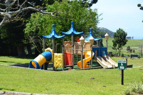 a playground with a slide in a park at The Farmers Lodge in Thorndale